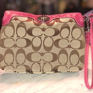 Medium Coach wristlet with pink leather accents
